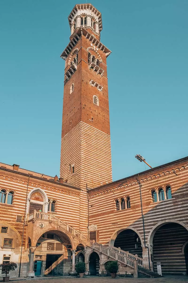 Best Things to do in Verona Italy - Michele standing below Torre dei Lamberti