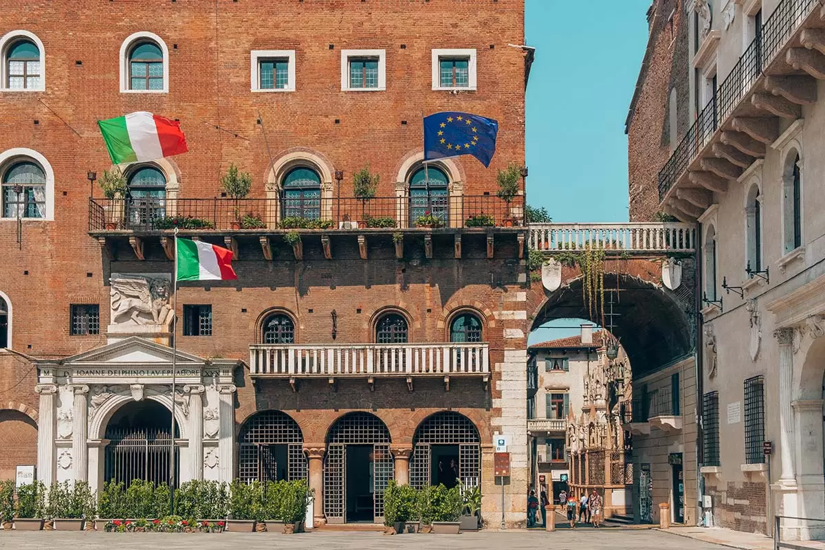Best Things to do in Verona Italy - Piazza dei Signori and Italian flags