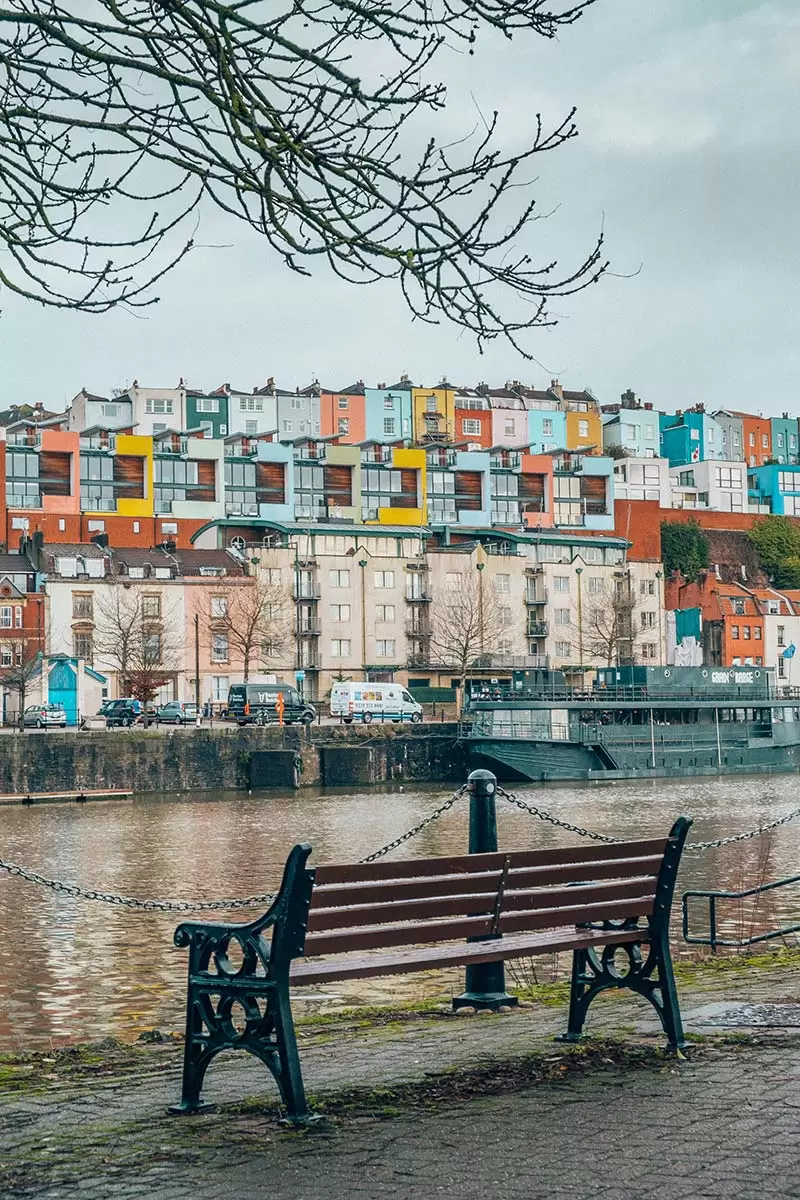 Bristol City Guide - Best Things to do in Bristol - Park bench on harbour with colourful houses
