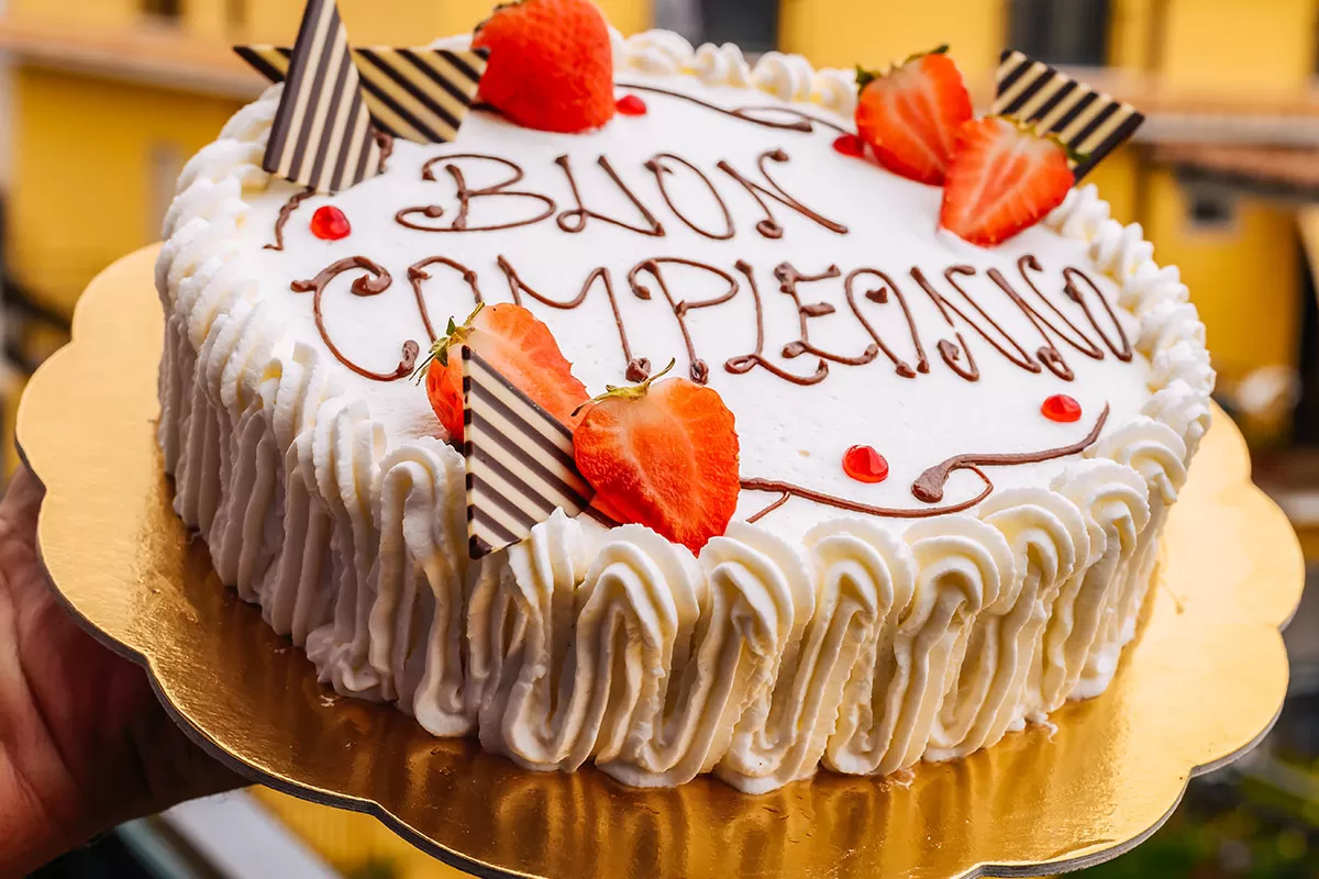 Happy birthday in Italian - Buon compleanno written on cake