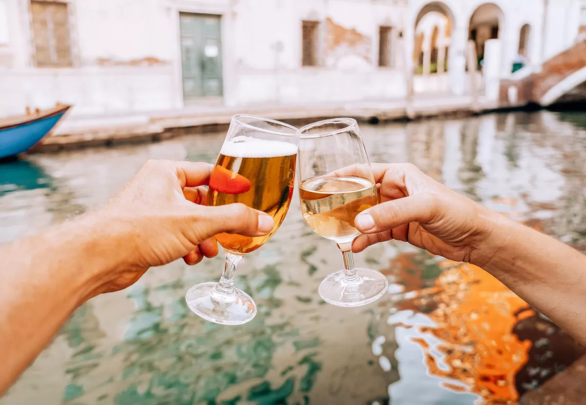 How to say cheers in Italian - friends toasting with beer and wine