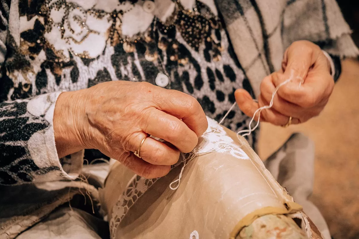 Things to do in Burano Italy - Woman making Burano lace