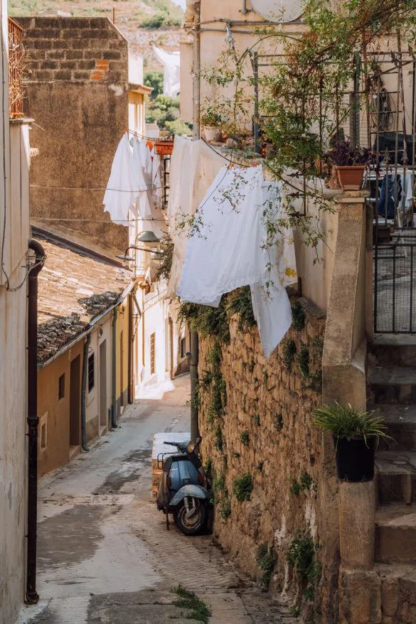 Things to do in Modica Sicily – Alley with washing and vespa Things to do in Modica Sicily - Alley with washing and vespa